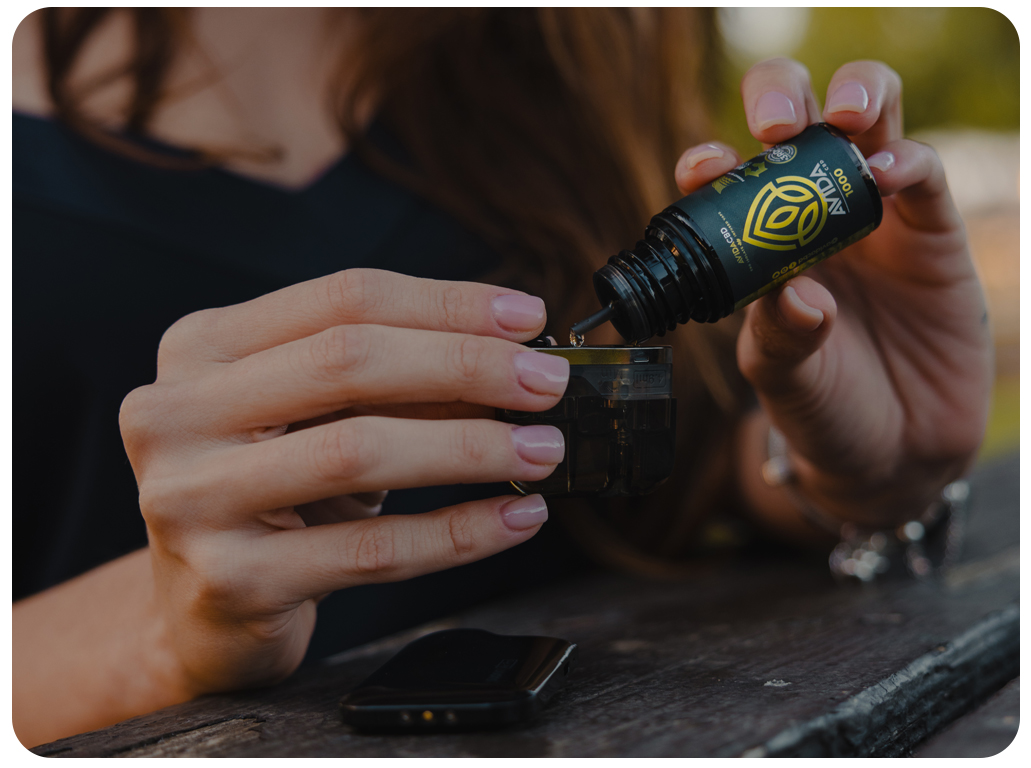 CBD Vape Additive Girl Pouring In Pod.