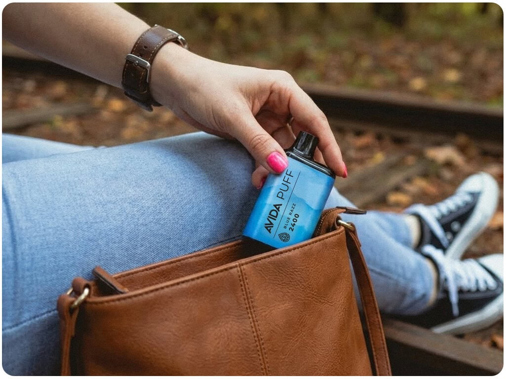 woman pulls avida cbd pen from her purse.