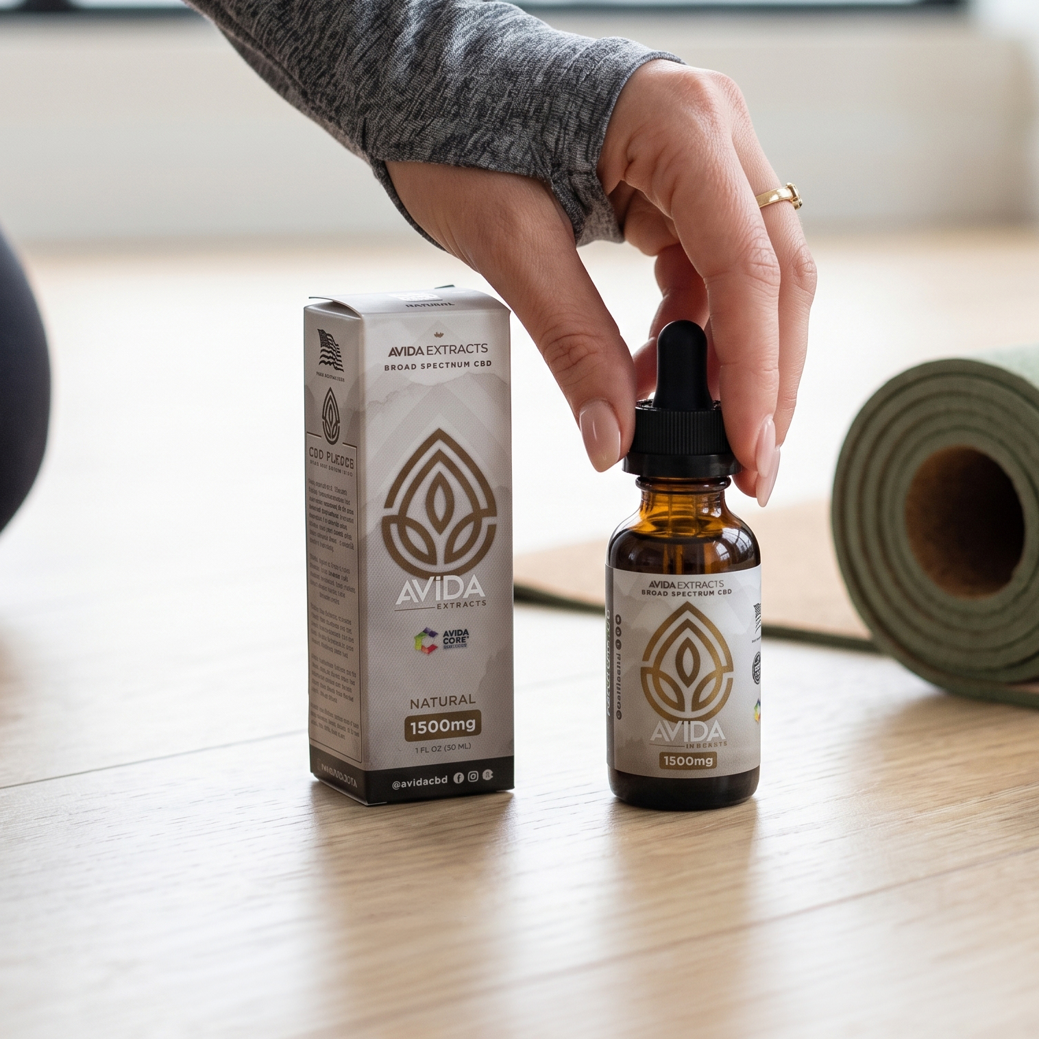 woman holding Broad spectrum cbd oil in yoga gym.